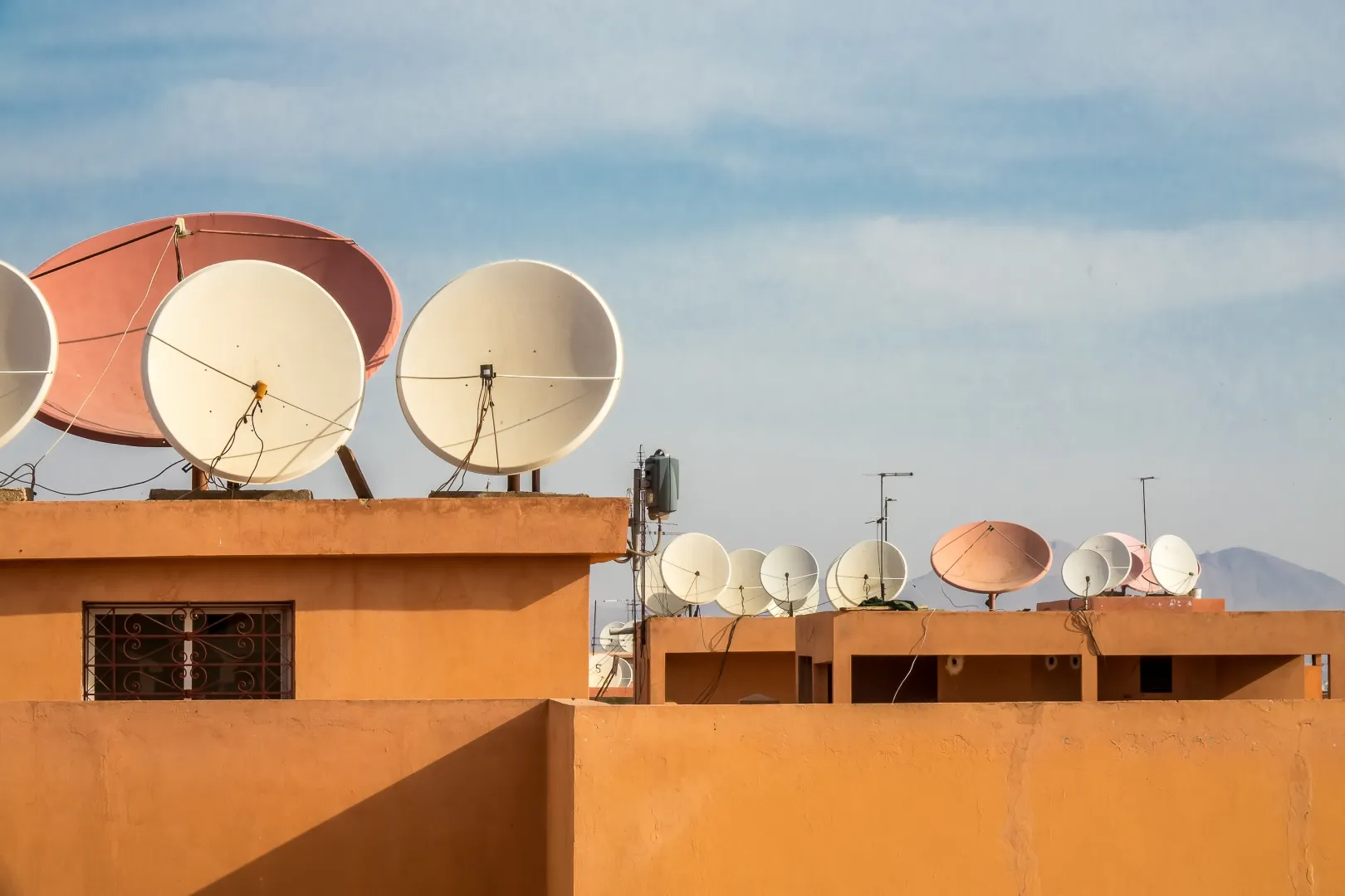 wide angle shot white satellite dishes roof building
